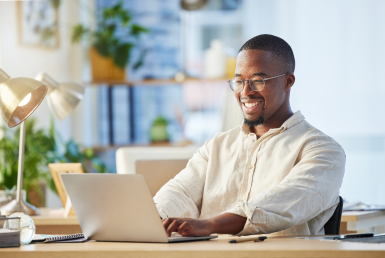 A young professional seated with his laptop